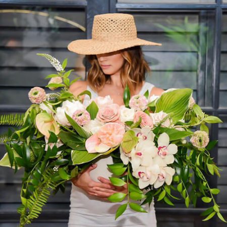 What Lola Likes holding a bouquet of flowers